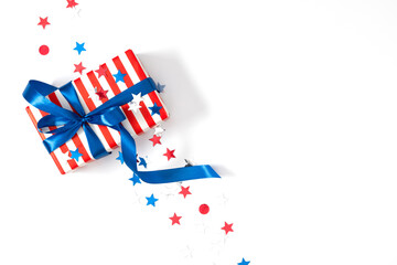 4th of July, USA Presidents Day, Independence Day, Happy Labor Day, US election concept. Gift striped box with bow, star confetti on white background. Flat lay, top view, copy space, banner