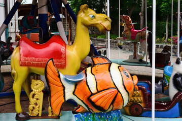 colorful carousel closeup detail in amusement park. vintage old, retro style. shiny animal figures....