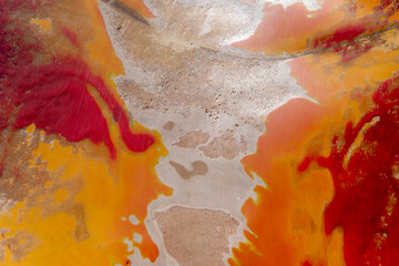 Abstract image from a public park slide with faded orange, red and white texture