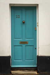 Turquoise wooden front door number 22