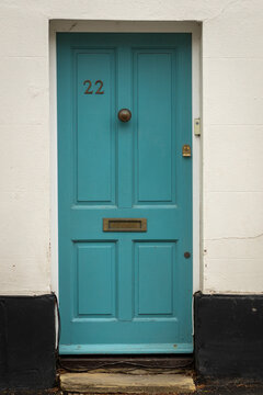 Turquoise wooden front door number 22