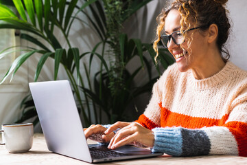 Home work and happiness concept lifestyle. One woman adult wearing eyewear and writing on laptop at...