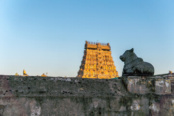 Nandhi facing the shiva temple gopuram in Chidambaram, ancient south Indian temple. Temple gopuram...