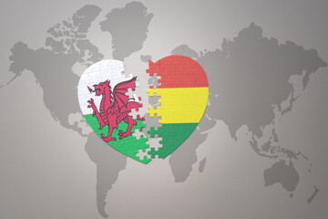puzzle heart with the national flag of bolivia and wales on a world map background.Concept.
