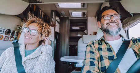 Camper van life concept. People living inside motorhome. Happy man and woman travel together with...