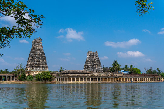 Two of Udayarpalayam temple gopuram built thousands of years before. Temple pond and its surrounding stairs with pillars on the side