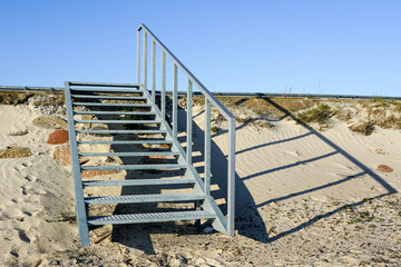 Public outdoor galvanized steel staircase with handrail for safety climbing on the embankment