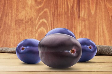 Fresh ripe tasty sweet plums on a background