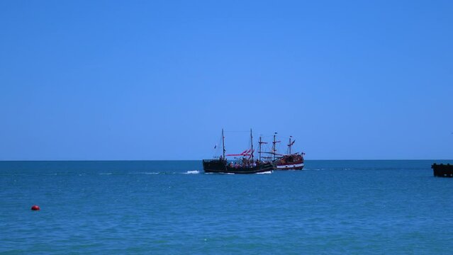 Two ships sail past each other. Old ships, a corvette and a battleship.