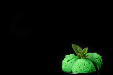 Delicious green mint ice cream on a dark background