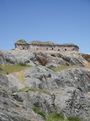 Marcahuasi chullpas, house made with stones on the top of a rocky mountain, archaeological remains in the mountains with a background of blue sky in South America