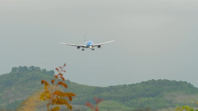 Jet airplane approoaching before landing at Phuket Airport. Aircraft arriving, side view