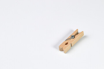 Mini wooden clothespin collection isolated on white background. Clothespins in different positions for household use or decorated.