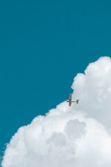 Plane crossing clouds 