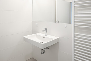 Fototapeta na wymiar White sink and mirror on light wall in bathroom