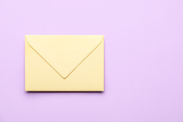 Yellow envelope on lilac background. Message concept