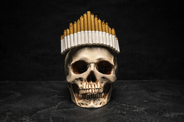 Human scull with crown made of cigarettes on dark background. Stop smoking concept