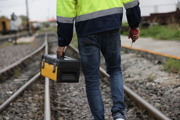Rail way engineer or Technician carry tool box to service rail transportation