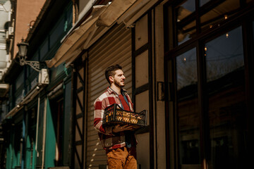 The Bar owner standing in front of his venue and opening the door.