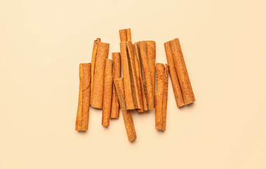 Aromatic cinnamon sticks on color background
