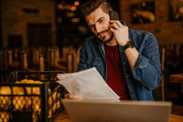 Restaurant owner calculating finance and bills of new business – Entrepreneur online using a...