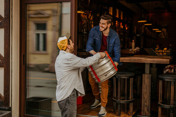 Restaurant worker receive goods from the supplier. - Powered by Adobe