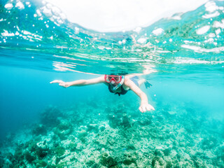 woman snorkeling in clear tropical sea