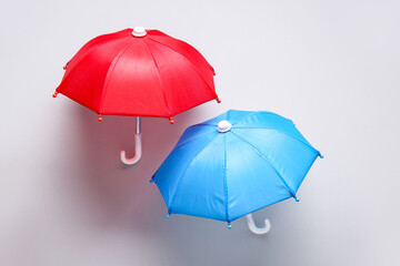 Mini umbrellas on white background