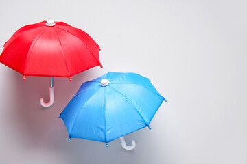 Mini umbrellas on white background