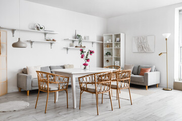 Interior of dining room with ikebana on table and shelves