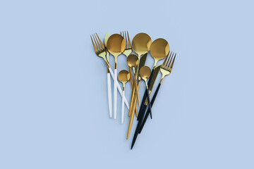 Golden cutlery on blue background