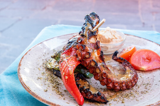 Grilled Octopus Served with Vegetables and Hummus in a Restaurant in Rhodes, Greece