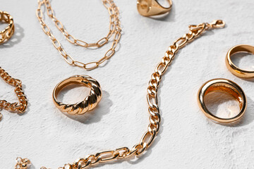 Beautiful golden jewellery on white textured background