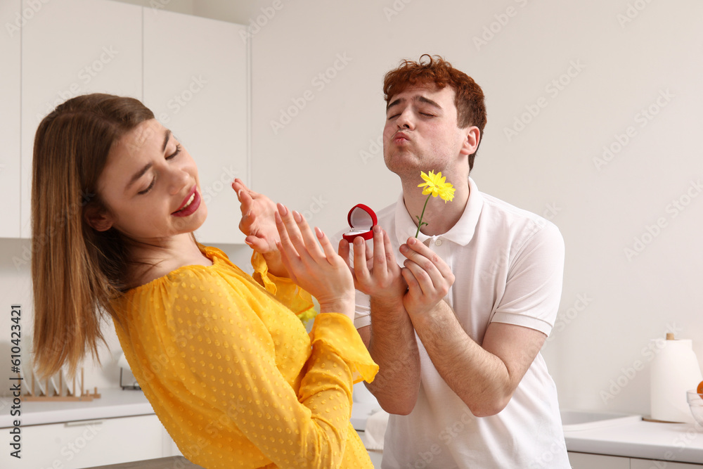 Canvas Prints Young woman rejecting marriage proposal from her boyfriend in kitchen