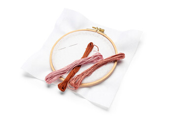 Embroidery hoop with canvas, needle and mouline threads isolated on white background