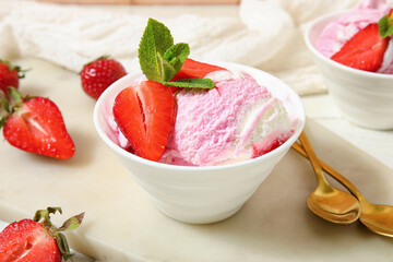 Bowl of strawberry ice cream on board, closeup
