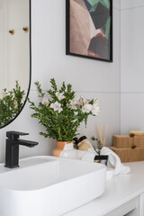 bathroom with washbasin, decor and bath supplies in stylish apartment