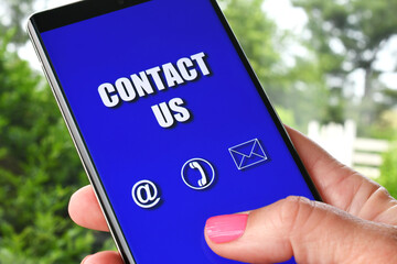 Holding phone with Contact Us screen
