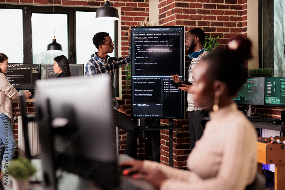 Poster africann american system engineers analyzing source code looking for errors, checking big tv monitor
