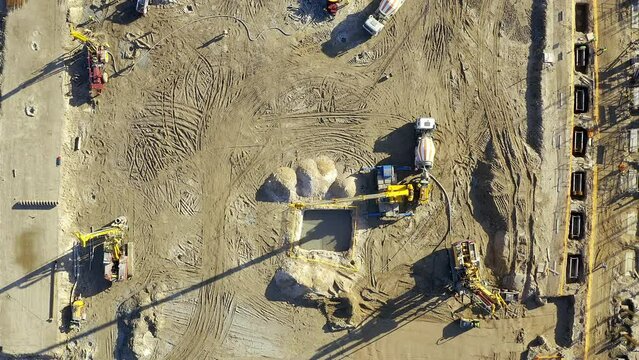 Land, construction site and engineering team working outdoor for architecture, development and foundation. Above engineer group of people on ground for infrastructure, labour and building or safety