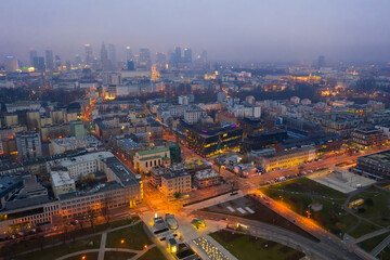 Fototapeta na wymiar Aerial view of illuminated cityscape of Warsaw at spring twilight, Poland..
