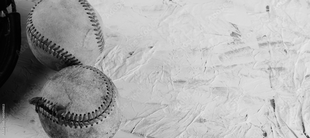 Poster old used baseball balls with torn seams on vintage texture background in black and white. - Posters