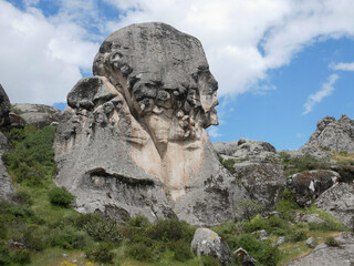 face of humanity, marcahuasi, face-shaped rock in the mountains of south america with a background...