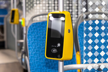 Contactless ticket validator on the bus. Payment of travel in municipal transport - obrazy, fototapety, plakaty