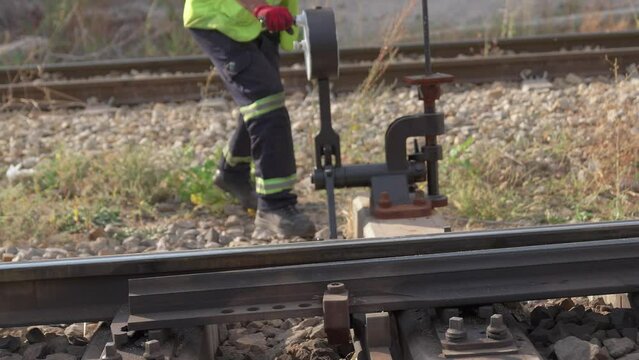 4K footage of switchman operating railroad switch of railway tracks manually in daytime. Signalman handling signals and points stock video. 