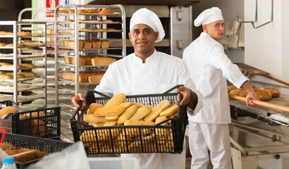 Portrait of successful baker during daily work in bakeshop