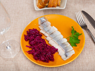 Fototapeta Delicious sliced lightly salted herring with beets served on platter obraz