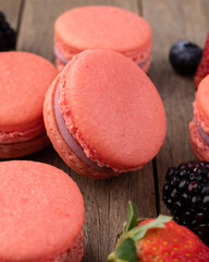 Berry macarons over wooden table
