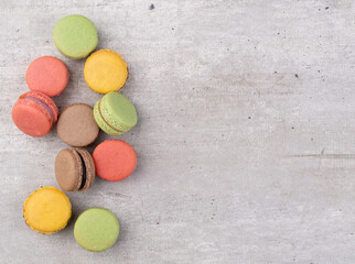 Assorted macarons over rustic background with copy space
