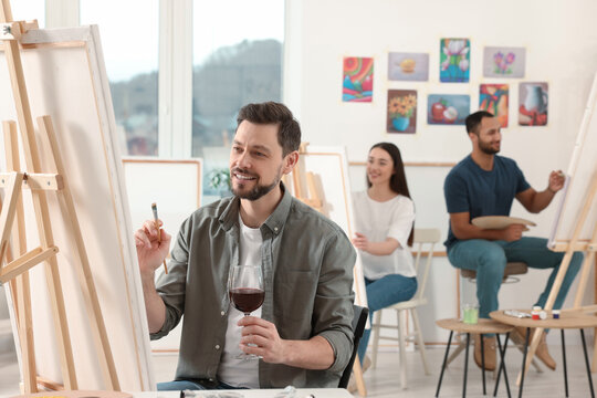 Group of students attending painting class in studio. Creative hobby